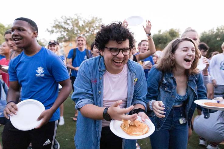 Students participate in the pancake flip during orientation week.