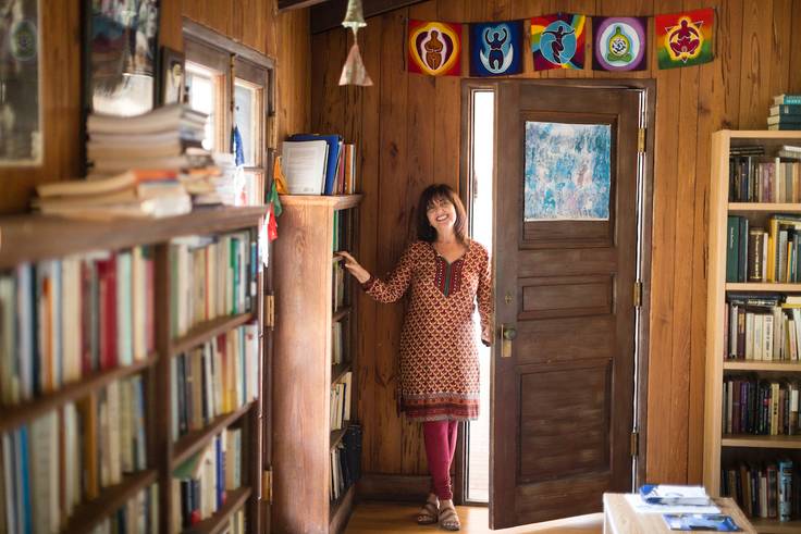 Rollins College professor, Yudit Greenberg, stands in her office near a bookcase.