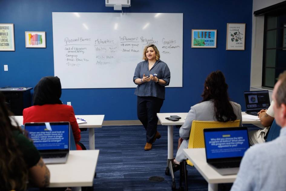 A professor explains a Health Leadership concept to a class of students.