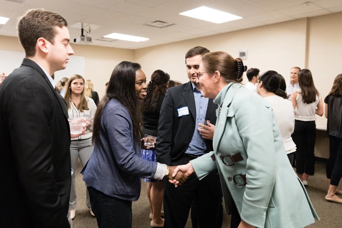 Rollins students socializing at a "mocktail" party.