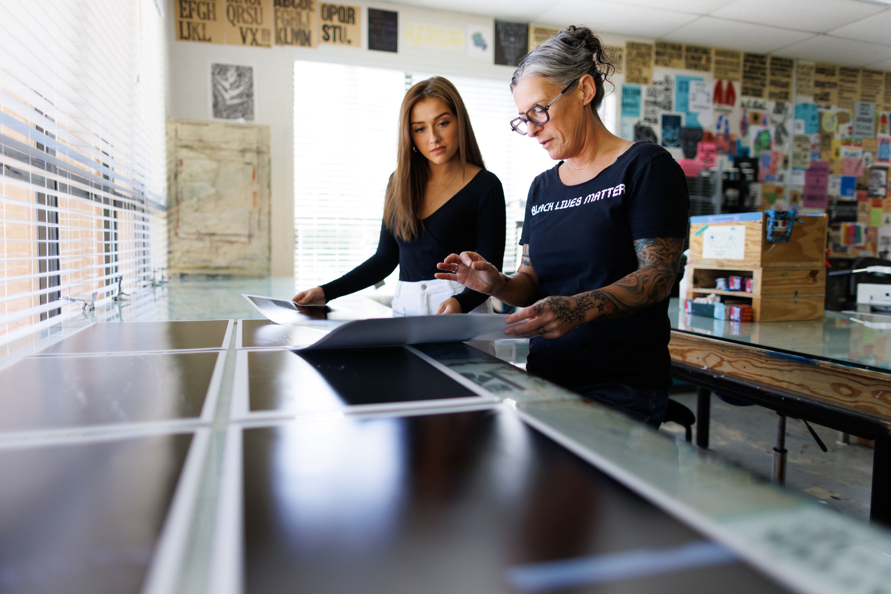A Rollins college art professor reviews a photo with a student.