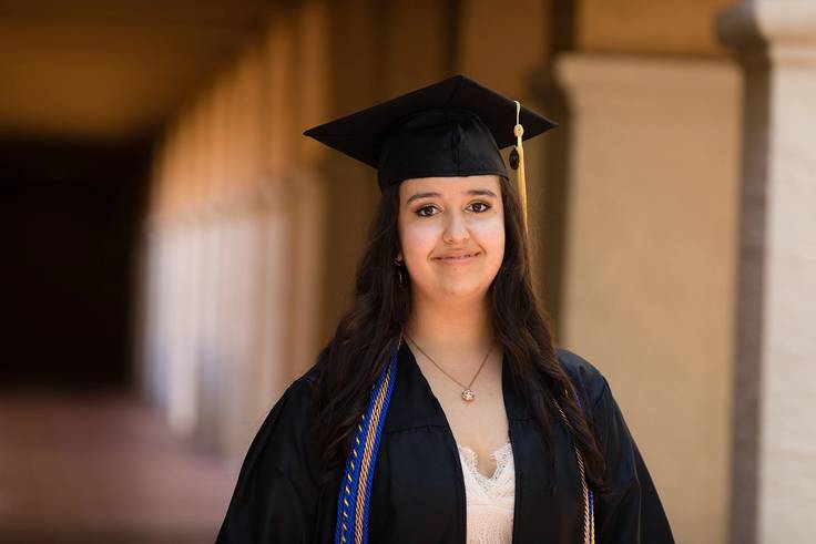 Rollins College valedictorian Maria Cedeno poses for a photo in her cap and gown.
