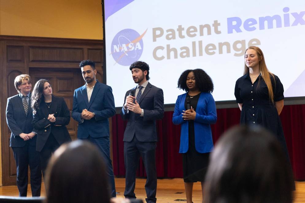 Student team presents project onstage at NASA Patent Remix Challenge event.