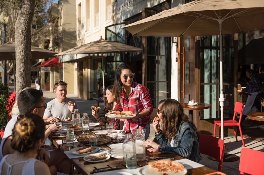 Students enjoying pizza at local favorite Prato.