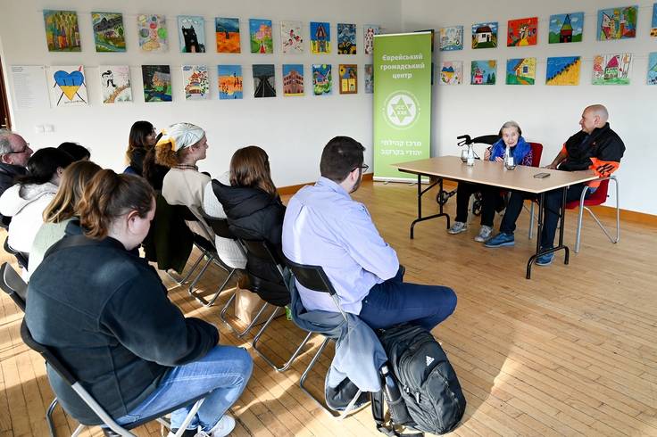 Students meet with a Holocaust survivor in Poland.