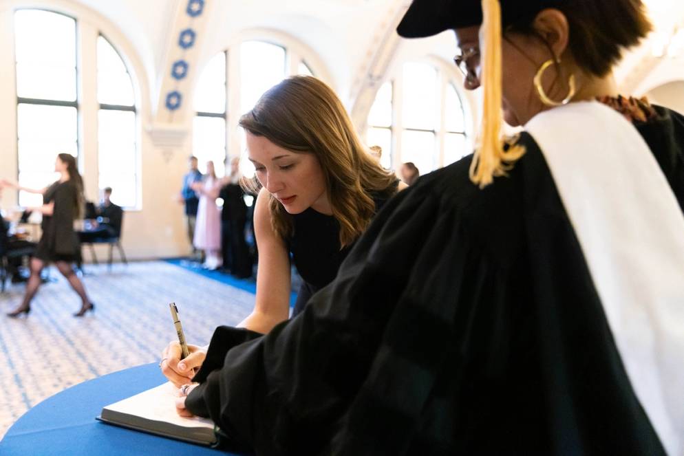 Reagan Cooney ’25 signing the Phi Beta Kappa book