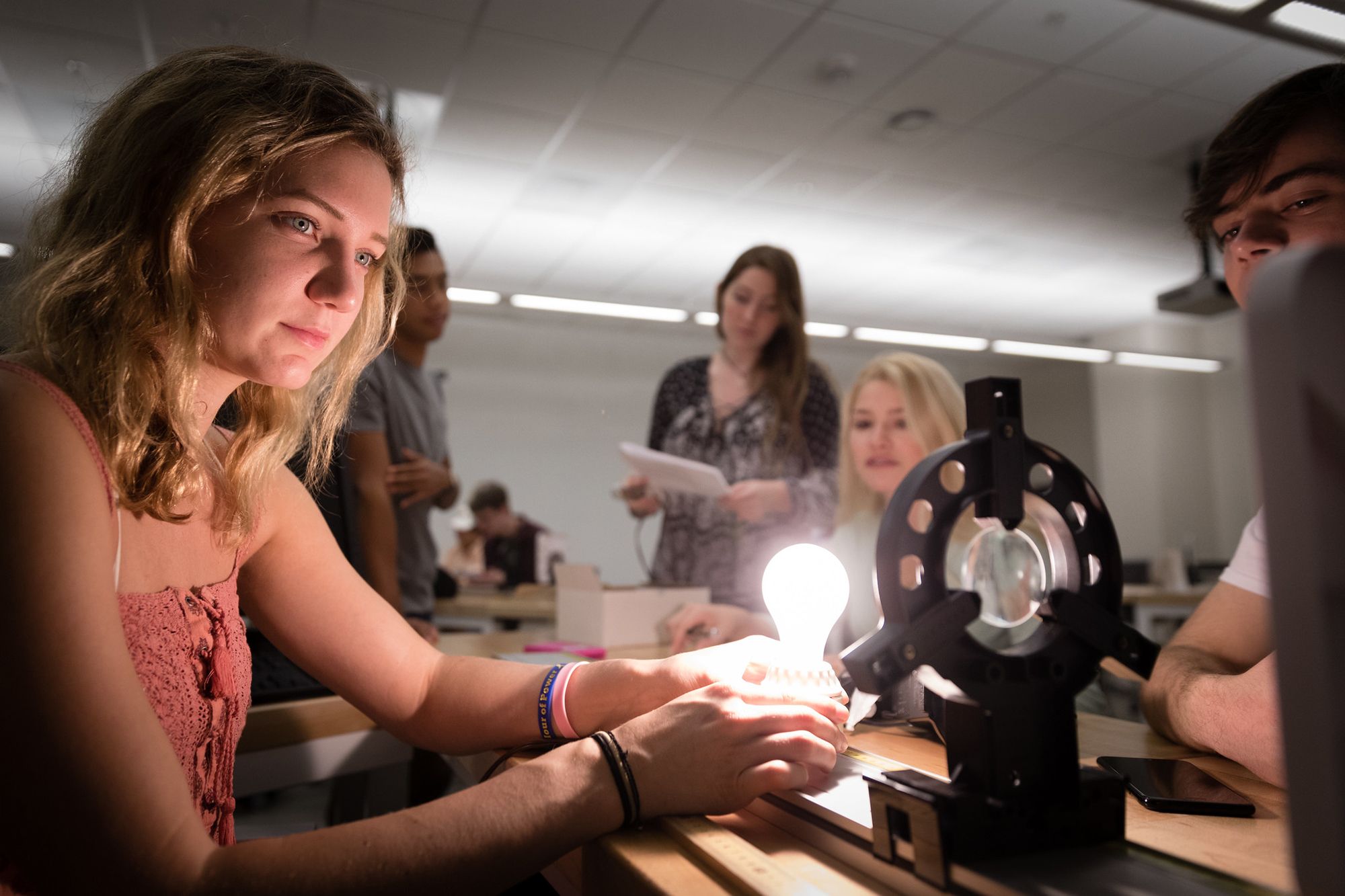 Physics students conduct an optics experiment.