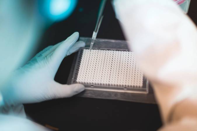 Student testing samples in a lab.