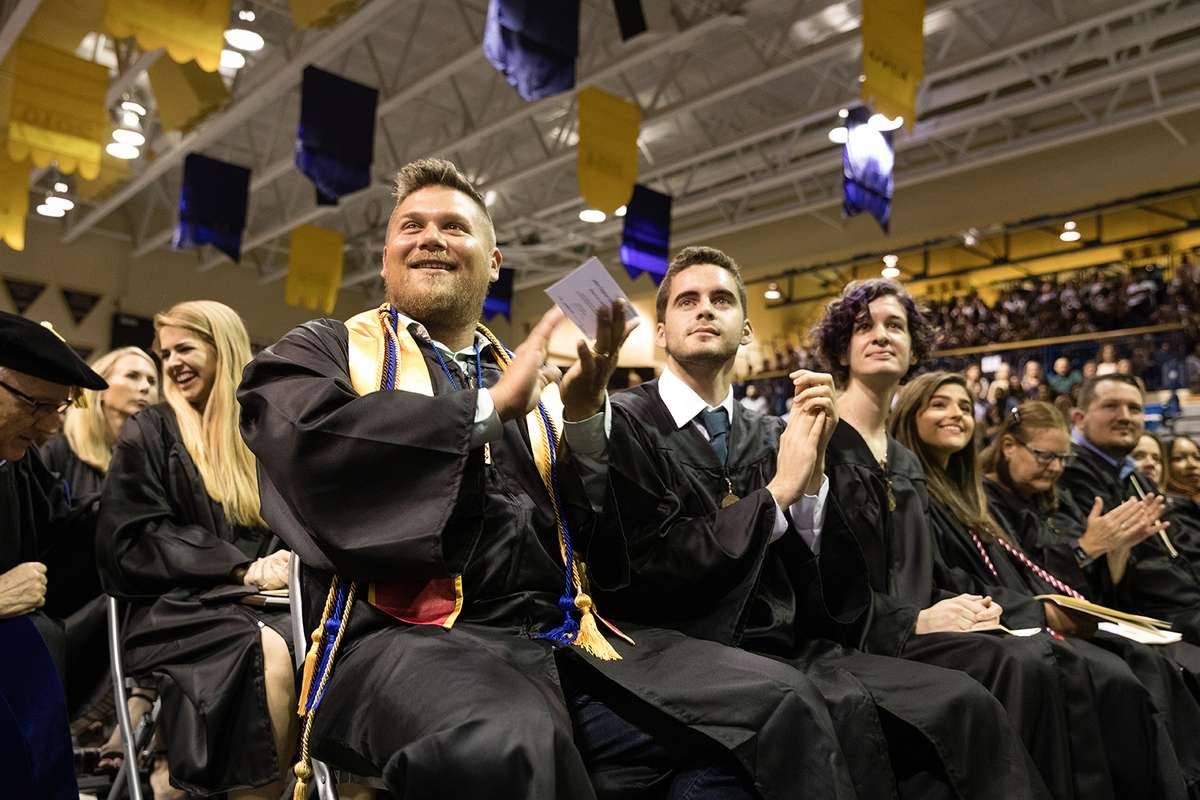 Graduating seniors applauding.