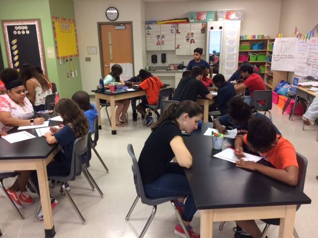 Rollins students working with local students on math projects.