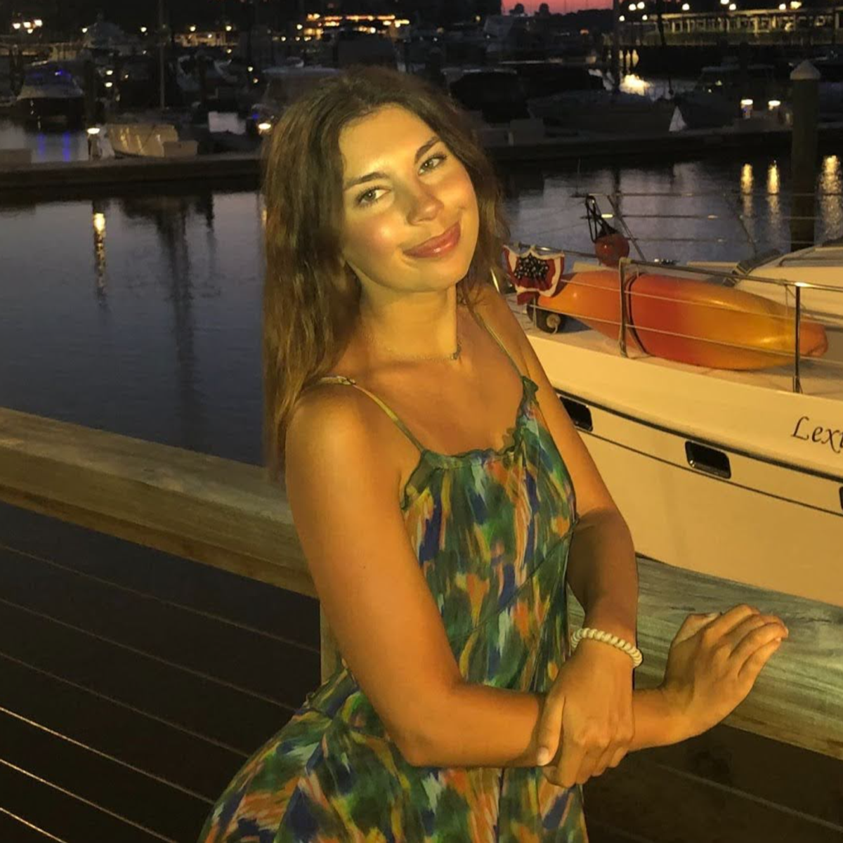 Rollins student Emma Westcott ‘25 poses in front of a boat