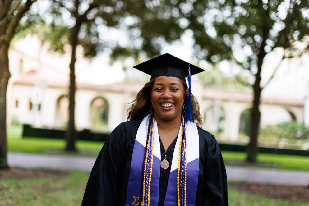 Tiffany Jones dressed in graduation regalia at Rollins College.