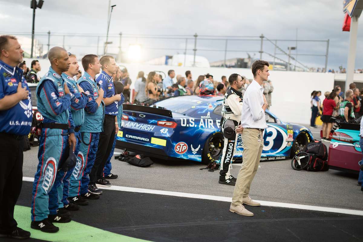 Ryan O’Donnell standing for the Star-Spangled Banner at a NASCAR event for which he was interning.