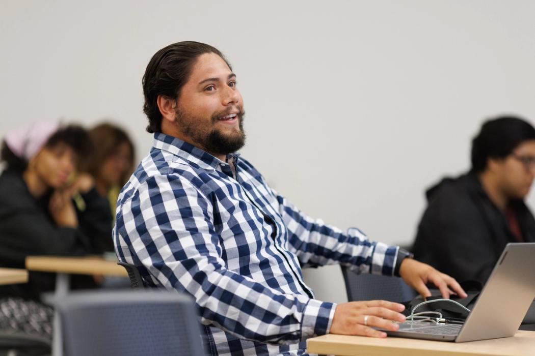 A male college student at a commencement ceremony.