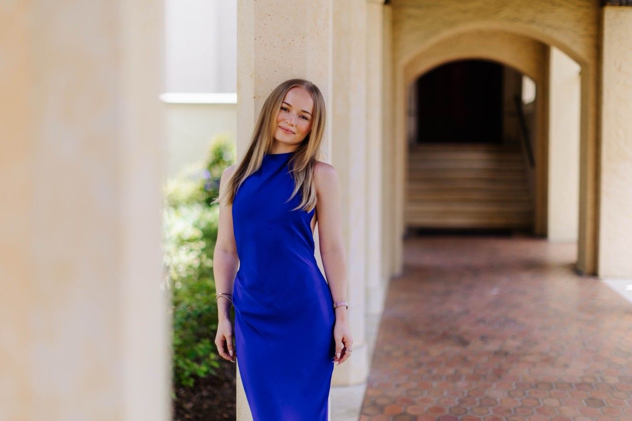 Rollins student in blue dress.