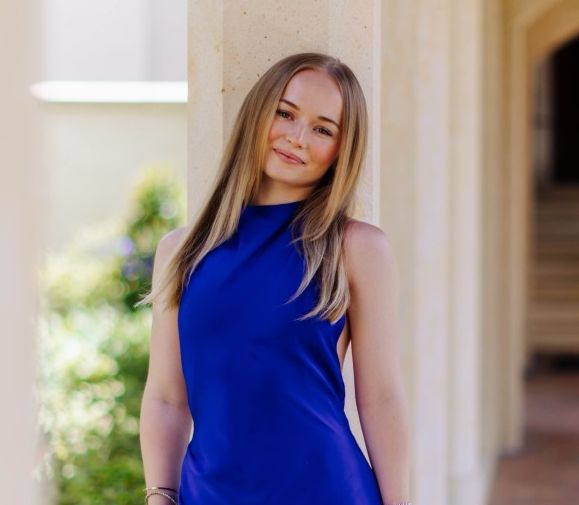 Rollins student in blue dress.