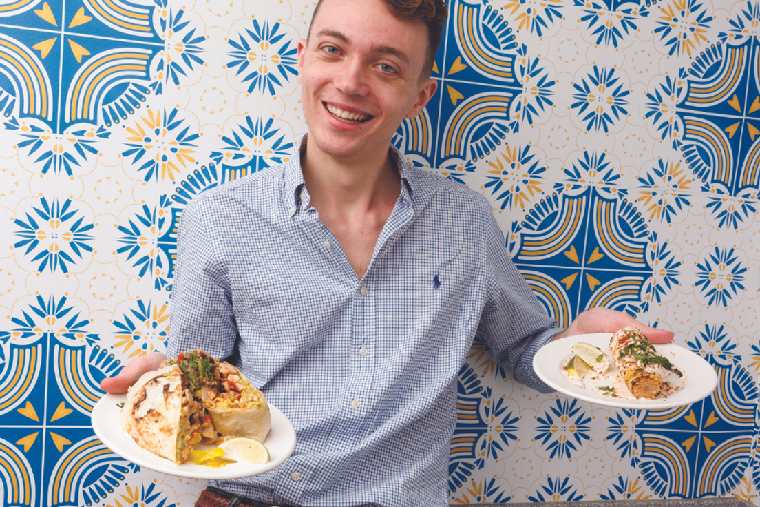 Rollins student Brendan Manning '23 with two plates of food