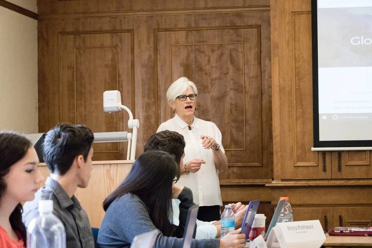 Political science professor Joan Davison guides students in their Model UN presentation.