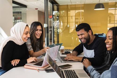 Four students at a table working together.