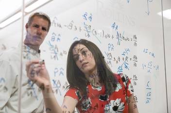 Arden Baxter and Professor Mark Anderson work on a whiteboard together.