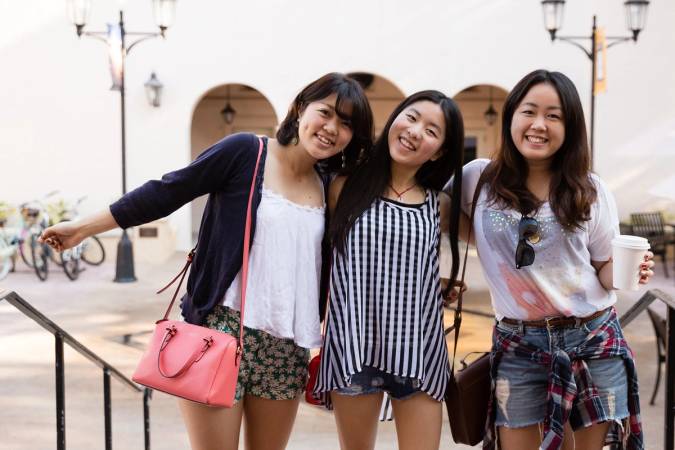 Three students smile and pose on Fox Day.