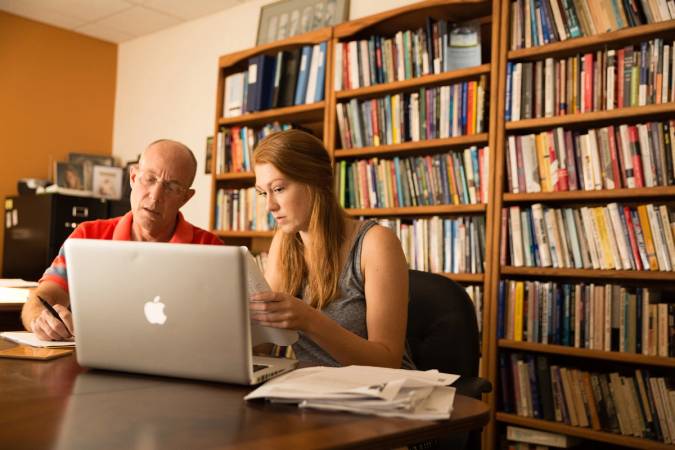 Political science professor Don Davison works with a student on original research.