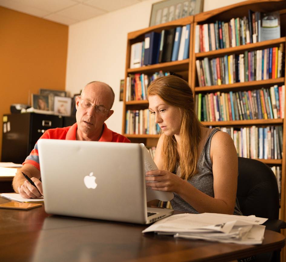 Rollins professor meets with a student in their office