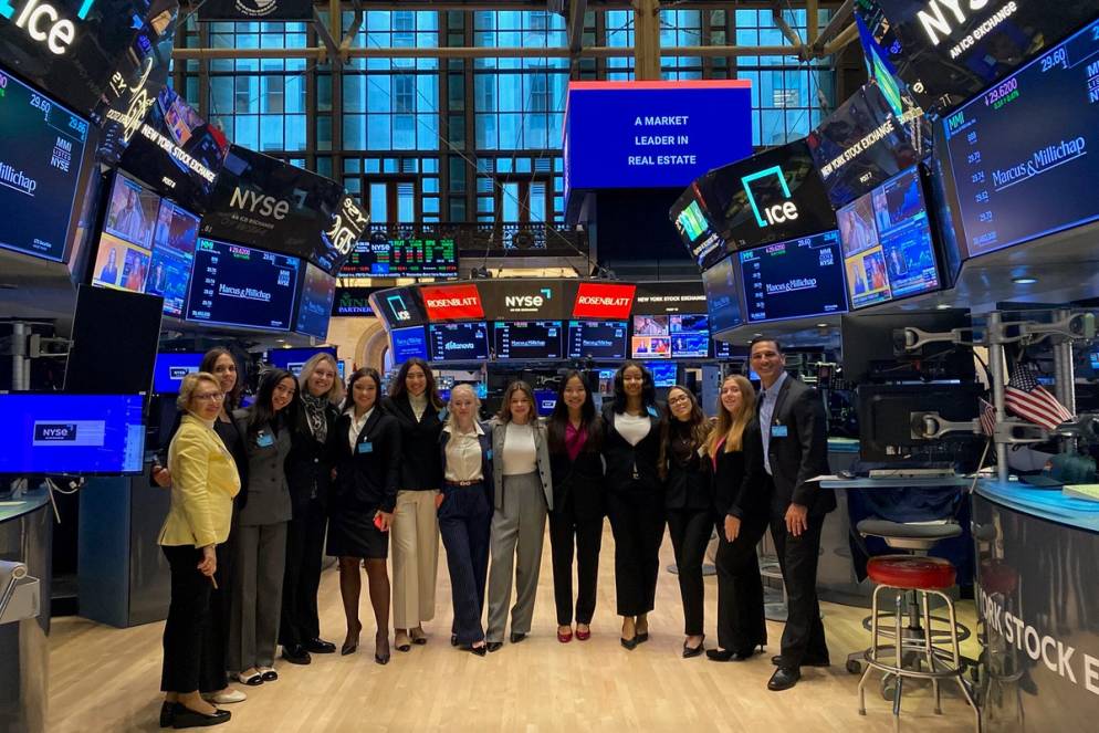 Women in Finance cohort poses together on the New York Stock Exchange floor.