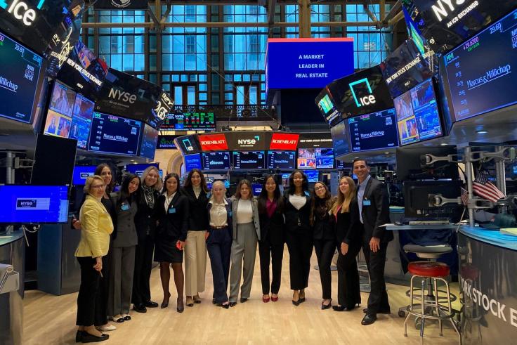 Women in Finance cohort poses together on the New York Stock Exchange floor.