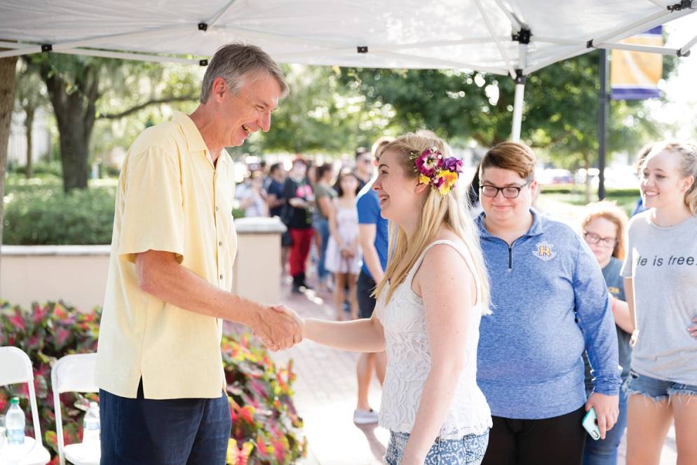 Grant Cornwell meeting a student during orientation