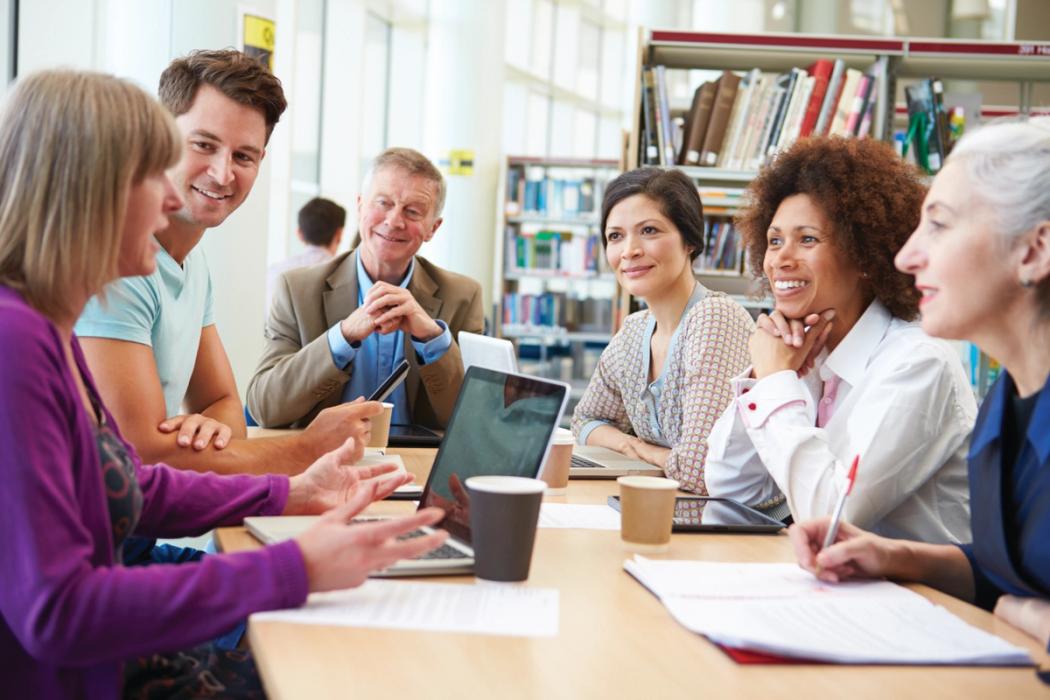 A group of adult learnings gathered for a study session.