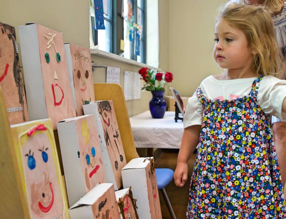 A photograph of a child looking at art 