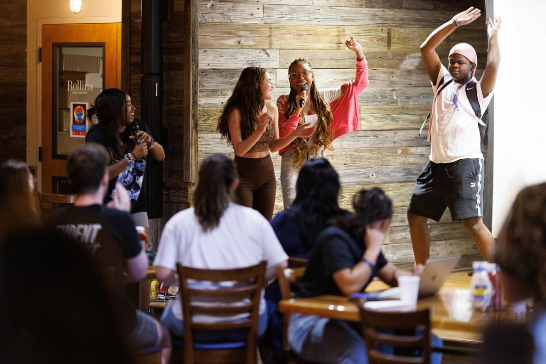 Students performing karaoke during Welcome Week activities