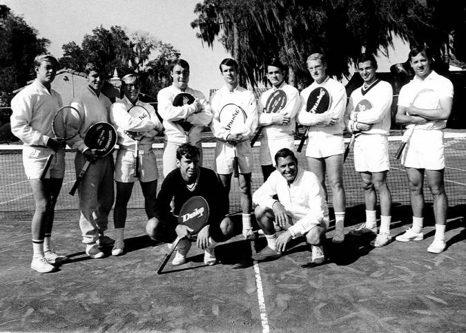 Norm Copeland ’50 pictured on a tennis court with his players in the 1950s.