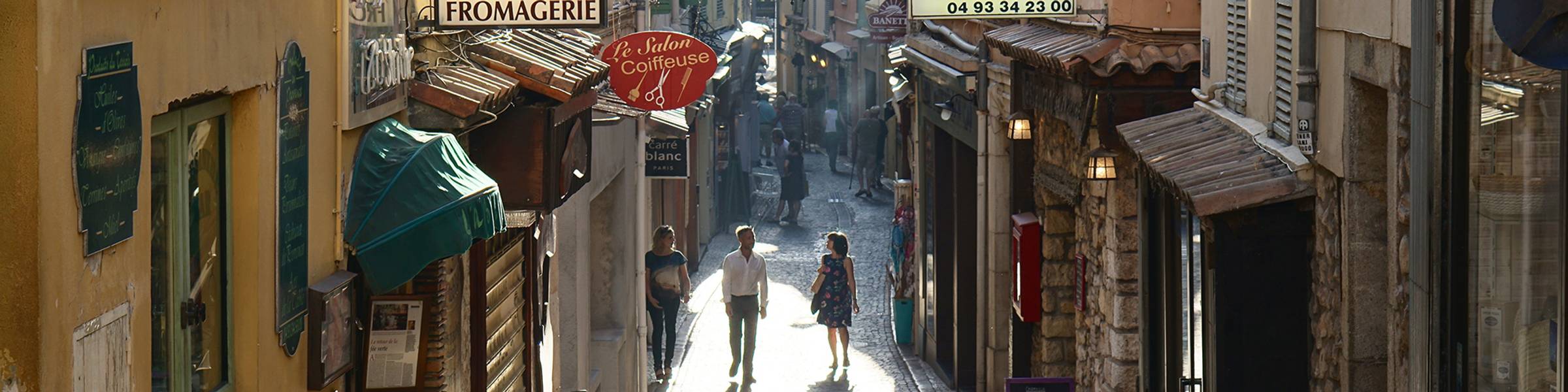 A couple walks down a street in Paris.