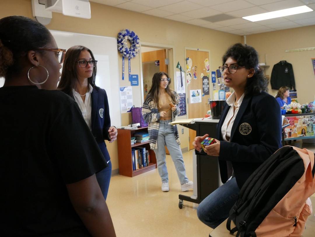 Rollins debate team members discuss standardized tests and college applications with students at Apopka High School.