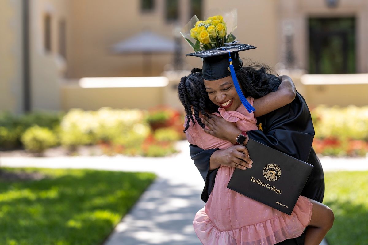 A Rollins grad hugging her daughter at commencement. 