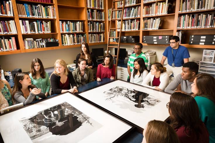 A group of Rollins students discuss art work.