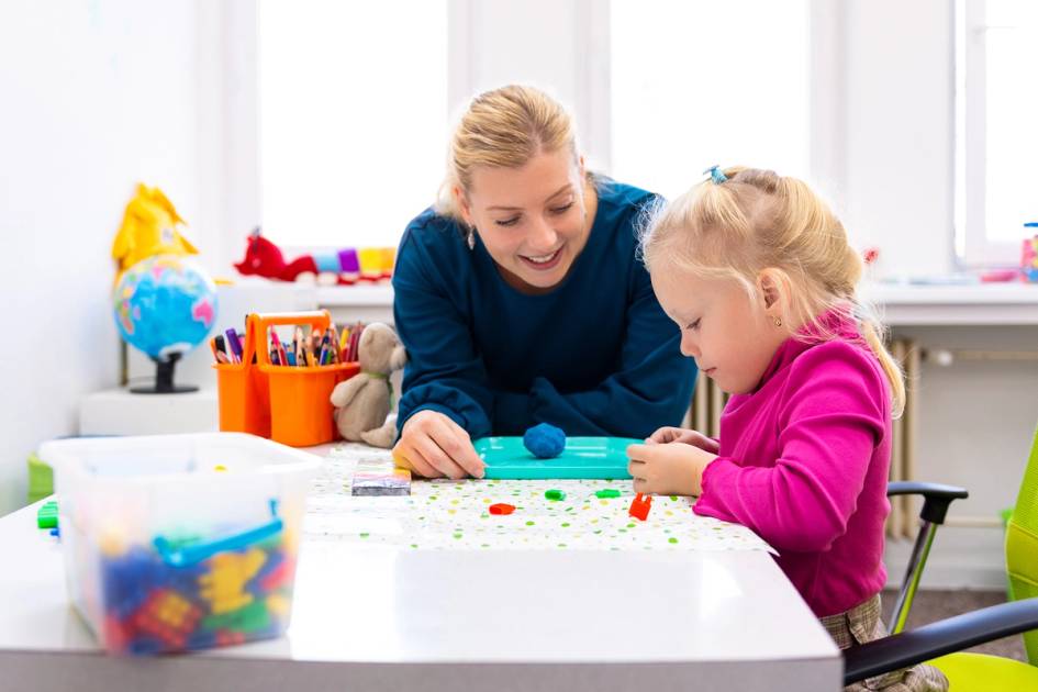 An applied behavior analyst observes a child who is making shapes out of play dough.