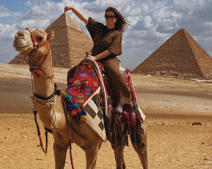 A Rollins student rides a camel while studying abroad in Egypt. 