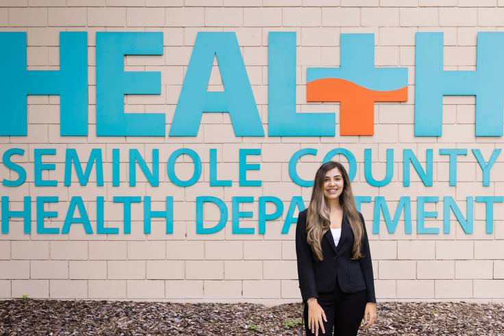 Rollins student Isabel Adamus poses in front of the Seminole County Health Department where she was an intern.