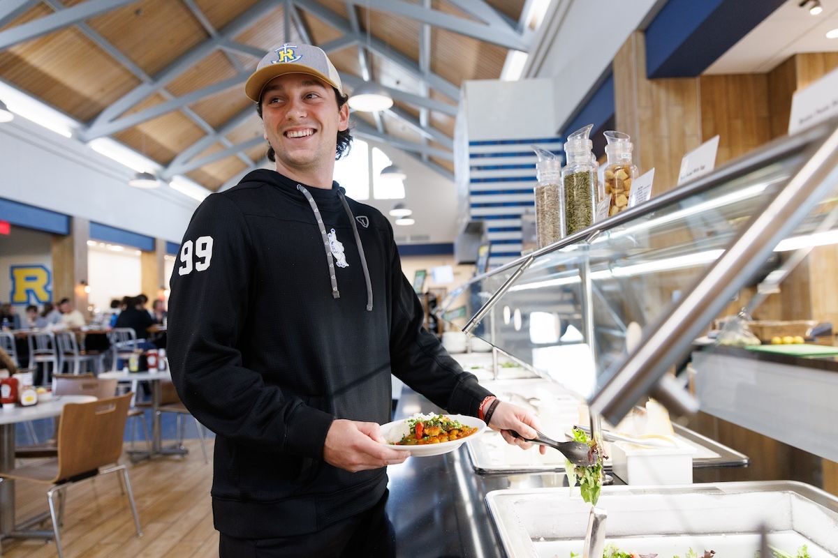 A Rollins student at the salad bar in the main campus dining hall at Rollins College.