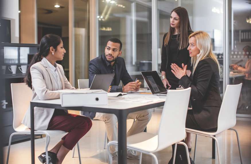 A group of human resource professionals work together in a conference room.