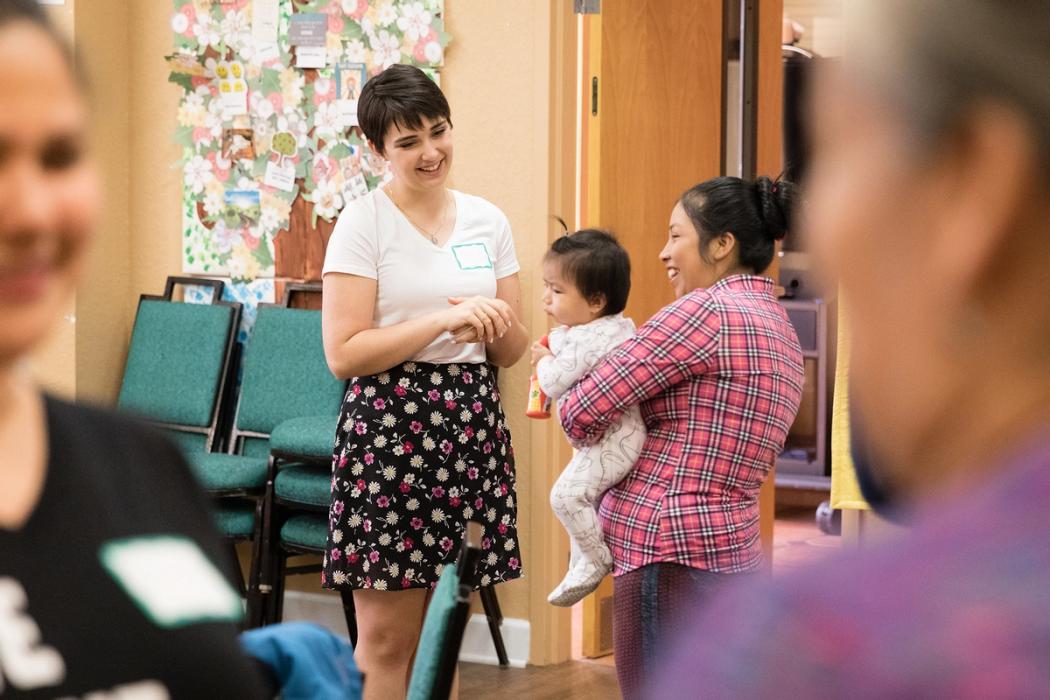 A student interviews a migrant farmworker for a research project.