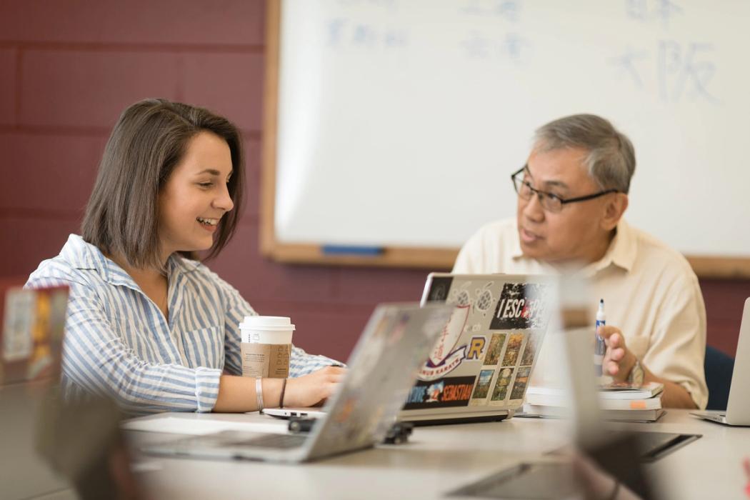 A student and a professor work one on one during a Rollins class.