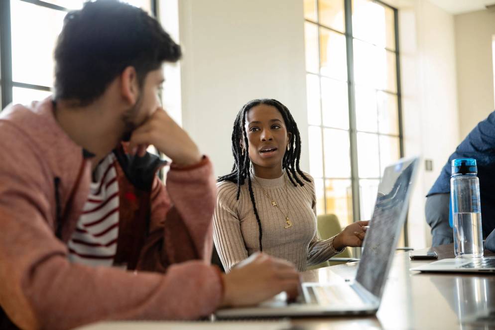 Farahana Cajuste ’21 collaborating with a fellow student in Kathleen W. Rollins Hall.