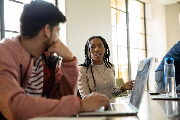 Farahana Cajuste ’21 collaborating with a fellow student in Kathleen W. Rollins Hall.