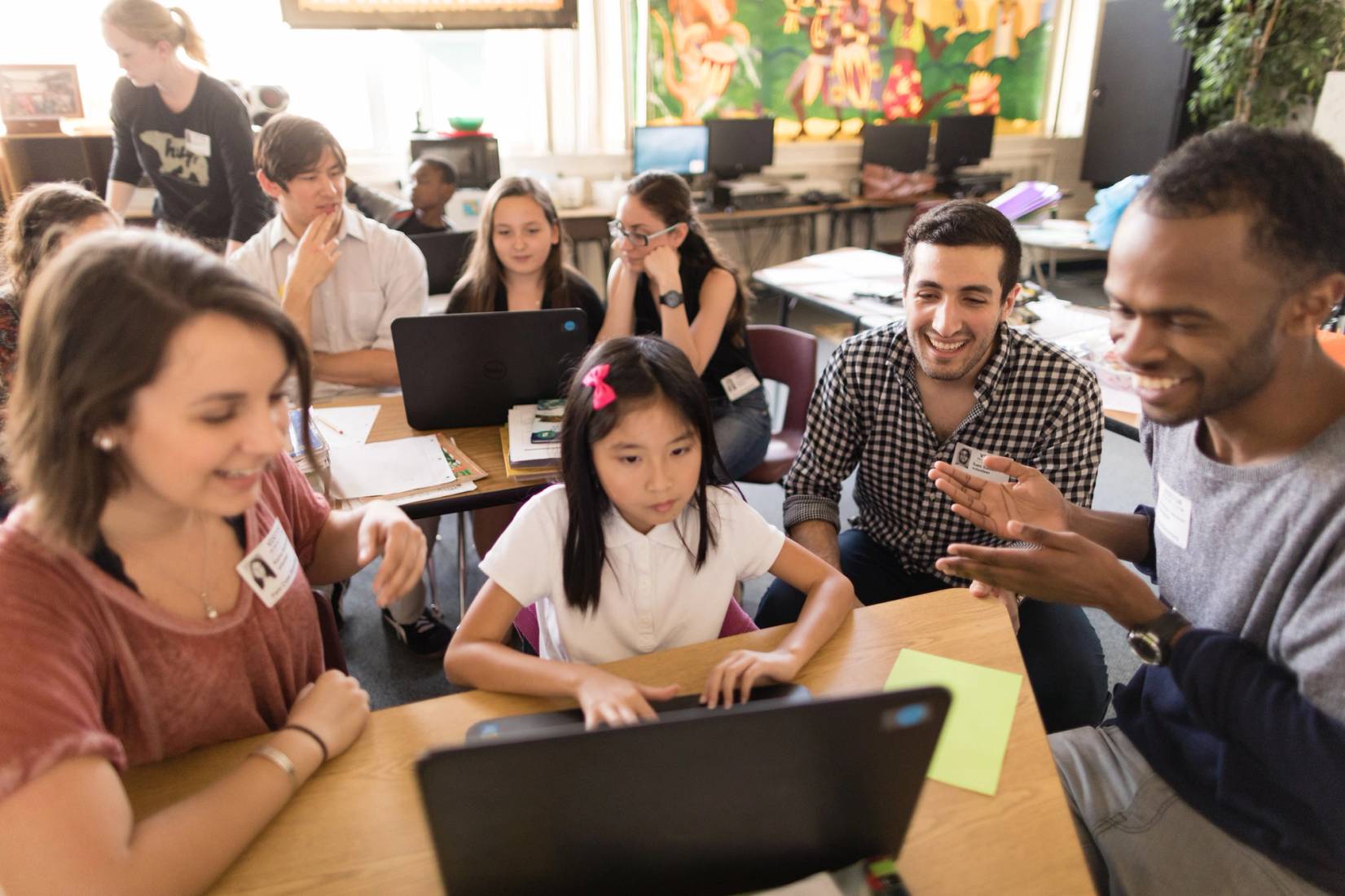 Sam Sadeh ’18 and students teach local schoolchildren how to code as part of funding made possible by Google.