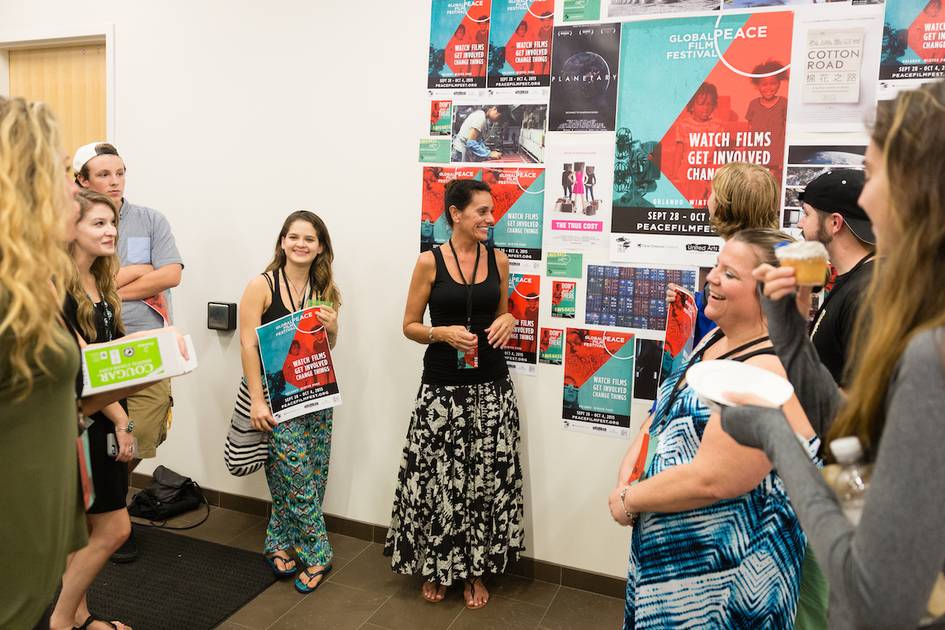 Rollins College professor talks with students at a film festival.