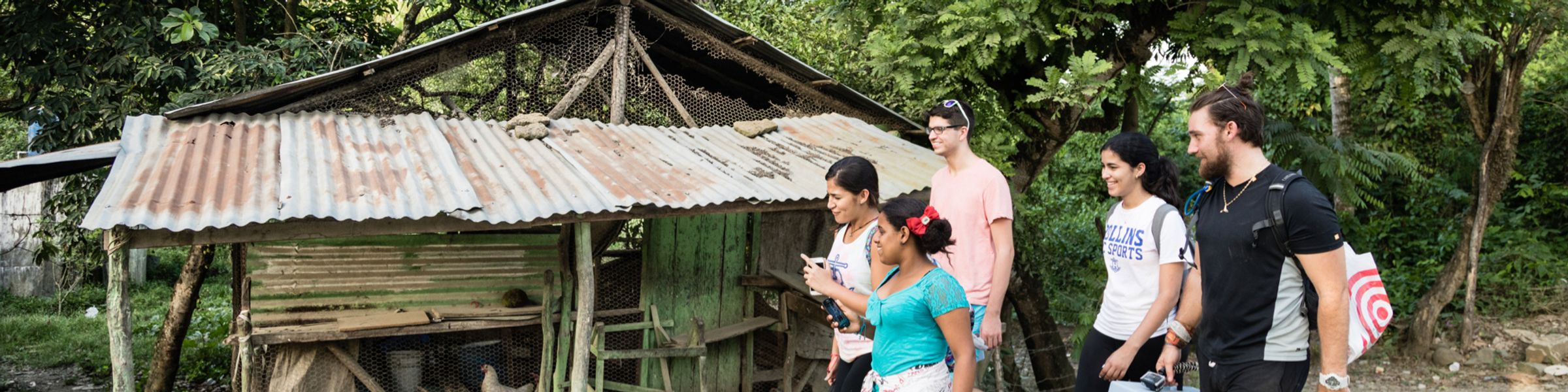 students in the Dominican Republic walking to help install water filters at a local home